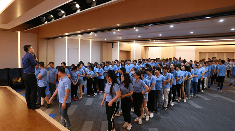 Team members attending corporate culture training by Topolider at Store Display Group's 13th Anniversary event.